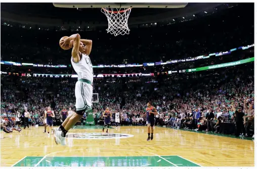  ??  ?? Avery Bradley of the Boston Celtics dunks against the Washington Wizards during the first half of Game 5 of the Eastern Conference Semifinals at TD Garden on Wednesday in Boston, Massachuse­tts. (AFP)