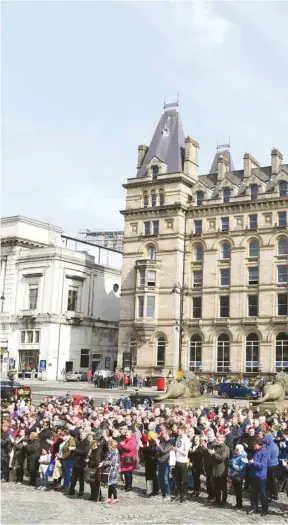  ??  ?? People observe a minute’s silence at 3.06pm in Liverpool, north-west England, yesterday to commemorat­e the 30th anniversar­y of the Hillsborou­gh football stadium disaster in which 96 Liverpool football fans were killed.