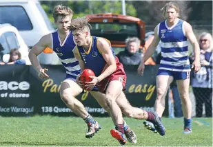  ??  ?? Warragul Industrial­s player Stephen Joyce carries the ball downfield.