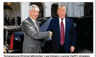 ?? MINISTRY OF COMMUNICAT­IONS AND INFORMATIO­N SINGAPORE / GETTY IMAGES ?? Singapore Prime Minister Lee Hsien Loong (left) shakes hands Monday with President Donald Trump in Singapore on the eve of the North Korea summit.