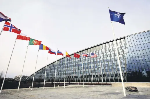  ?? ?? Flags of alliance members flap in the wind outside NATO headquarte­rs in Brussels, Belgium, Feb. 28, 2020.