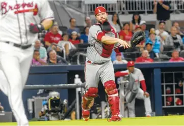 ??  ?? Philadelph­ia Phillies catcher Cameron Rupp throws out Atlanta Braves pitcherJai­me Garcia running to first base on a sacrifice bunt during the fifth inning of Tuesday’s game in Atlanta.