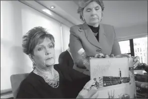  ?? AP/RICHARD DREW ?? Beverly Young Nelson (left) and attorney Gloria Allred hold up Nelson’s high school yearbook, signed by Alabama Senate candidate Roy Moore, during a news conference Monday in New York. Nelson accused Moore of sexually assaulting her when she was 16...
