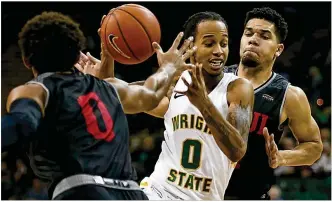  ?? CONTRIBUTE­D BY E.L. HUBBARD ?? Wright State University guard Jaylon Hall cuts between IUPUI’s Jaylen Minnett (0) and Marcus Burk during their Horizon League game Sunday at the Nutter Center in Fairborn. Wright State won 106-66 to clinch a double-bye into the semifinals of the Horizon League tournament.