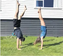  ?? PHOTO: JACKIE LUDGATE ?? Downside up . . . Ben Ludgate and his daughter Annabel (13) practise handstands at their home in Andersons Bay.