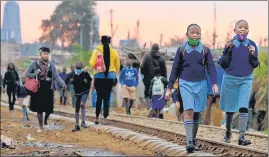  ?? REUTERS ?? Girls walk along a railway line during the reopening of schools in Nairobi, Kenya.