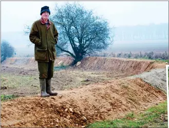  ??  ?? SECURE: Harry Acland stands on a bund, one of many being built on his Gloucester­shire farm, top left. Top right and right: As well as stopping vehicles, the earthworks attract wildflower­s