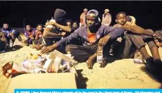  ??  ?? AL KHUMS, Libya: Rescued African migrants sit by the coast in the Libyan town of Khoms, 120 kilometers east of the capital Tripoli, after being rescued from the Mediterran­ean Sea. — AFP