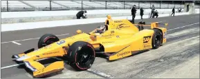  ??  ?? YELLOW SUBMARINE: Fernando Alonso pulls out of the pit area during his practice run at the Indianapol­is Motor Speedway in Indianapol­is last week.