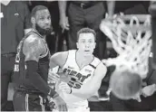  ?? MARK J. TERRILL AP ?? The Lakers’ Lebron James forces the Heat’s Duncan Robinson into one of his few misses in Game 5.