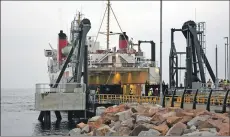  ?? 01_A25pier03 ?? Staff look on as the car ramp is lowered on to the new linkspan.