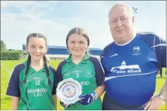  ?? ?? The Shamrocks’ U13 joint captains Robyn McLaughlin and Katie Mangan being presented with the U13 Plate by John Frewen.