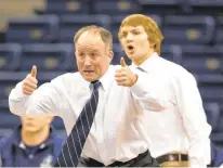  ?? STAFF FILE ?? Martin, pictured shouting directions to his Old Dominion wrestlers during a 2014 match against Missouri, won 172 dual matches to tie a school record. The Monarchs discontinu­ed their program last spring.