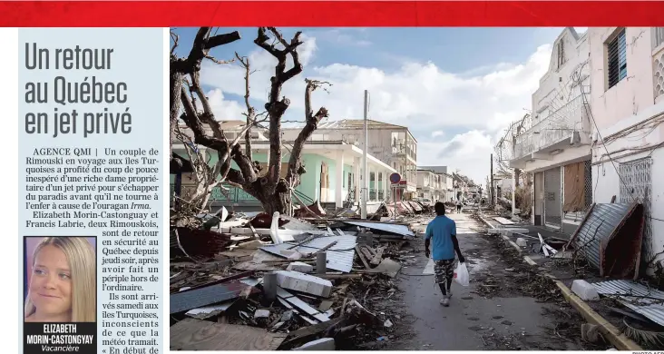  ?? PHOTO AFP ?? Un homme transporte un sac de provisions à travers les rues détruites de la ville de Marigot, sur l’île de Saint-martin, où au moins 11 personnes ont perdu la vie lors du passage de l’ouragan Irma, qui a détruit la quasi-totalité de l’île.