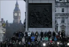  ?? THE ASSOCIATED PRESS ?? People observe a minute’s silence at a vigil for the victims of Wednesday’s attack at Trafalgar Square in London on Thursday.