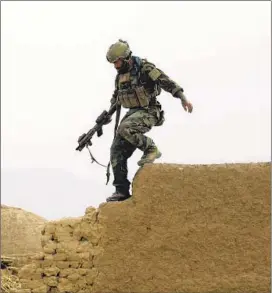 ?? Maya Alleruzzo Associated Press ?? A MEMBER of U.S. special operations on joint patrol with Afghan National Army soldiers in Farah province. The likelihood of mission accomplish­ment is nil.