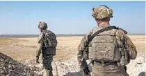  ?? MAYA ALLERUZZO/AP ?? U.S. soldiers survey the safe zone between Syria and the Turkish border in September near Tal Abyad, Syria.