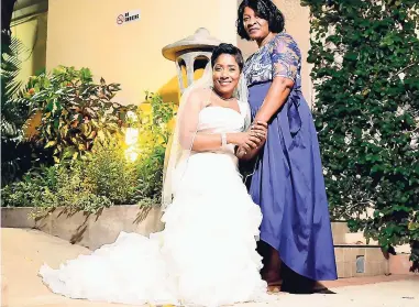  ??  ?? The beautiful bride, Lyndia Soutar (left), and her mom Mavie Romain at her wedding at the Courtleigh Hotel and Suites in Kingston.