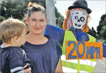  ??  ?? School mum and road safety campaigner Beth Hadden with Nell the scarecrow, reminding drivers to slow down on the approaches to Lochnell Primary School.