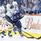  ?? JOHN WOODS/ASSOCIATED PRESS ?? Winnipeg’s Brandon Tanev (13) fights for the puck while being hounded by Vegas’ Reilly Smith, left, and Jason Garrison in the second period of Thursday’s game.