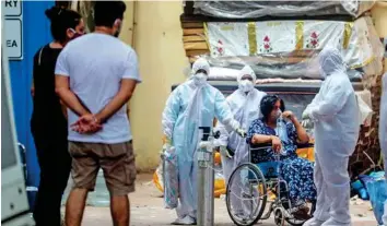  ?? AP ?? ■
Health workers attend a patient at jumbo Covid-19 centre in Mumbai yesterday. New infections are rising faster in India than any other place in the world, capsizing its fragile health system.