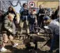  ?? IDA MARIE ODGAARD FOR THE ASSOCIATED PRESS ?? Citizens of the free village Christiani­a jointly dig up the cobbleston­es at Pusher Street, in Copenhagen, Denmark on Saturday for scheduled work