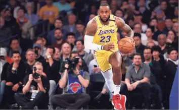  ?? Kathy Willens / Associated Press ?? Lakers forward LeBron James drives down the court during a 2020 game against the Knicks.