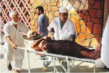  ?? Reuters ?? An injured man is rushed to a hospital after a suicide attack in Nangarhar province, Afghanista­n, yesterday.