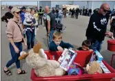 ?? ?? Swift Current resident Shelby Senicar and her sons Benjamin (6) and Jackson (4) donate toys to the Salvation Army during the Toy Run, Sept. 17.