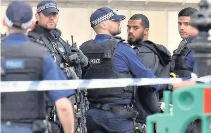  ?? Dominic Lipinski ?? > Armed police at the scene after a person was arrested following the incident in Whitehall on Thursday