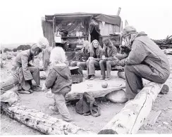  ??  ?? This photo by Seth Roffman shows young people gathered for a meal at the New Buffalo commune near Taos. COURTESY OF MUSEUM OF NEW MEXICO PRESS