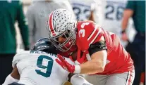  ?? JAY LAPRETE / AP /FILE ?? Michigan State defensive back Ronald Williams (left) tackles Ohio State tight end Mitch Rossi on Nov. 20, 2021, the previous time the two teams met. Ohio State scored on its first seven possession­s en route to a 56-7 win at home.