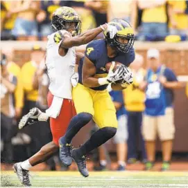  ?? GREGORY SHAMUS/GETTY IMAGES ?? Maryland cornerback Tino Ellis works to defend Michigan wide receiver Nico Collins during Saturday’s game in Ann Arbor. Ellis leads the Terps with seven pass breakups.