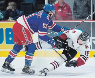  ?? PETER LEE WATERLOO REGION RECORD ?? Kitchener Rangers’ Michael Vukojevic, left, checks the Storm’s Liam Hawel in first-period Ontario Hockey League action at the Sleeman Centre in Guelph on Sunday.