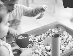  ??  ?? Children engaging in sensory play during a previous Benih Parents workshop. — Photo courtesy of Benih Parents