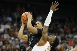  ?? JEFF ROBERSON — THE ASSOCIATED PRESS ?? Miami guard Isaiah Wong shoots over Texas guard Marcus Carr in the first half of an Elite 8game in the Midwest Regional of the NCAA Tournament on Sunday in Kansas City, Mo.