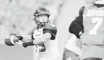  ?? MARK TAYLOR THE CANADIAN PRESS ?? Calgary Stampeders quarterbac­k Bo Levi Mitchell attempts a pass during first-half CFL action against the Saskatchew­an Roughrider­s at Mosaic Stadium in Regina on Saturday. The Stampeders won, 34-22.