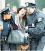  ?? JOE TABACCA/AP FILE ?? New York City cops help a hurt women away from the scene of the World Trade Center truck bombing on Feb. 26, 1993.