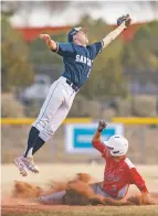  ?? CRAIG FRITZ/FOR THE NEW MEXICAN ?? Santa Fe High’s Dominic Arellano catches a throw as Valencia’s Robert Connolly slides safely into second base during the second game of a Tuesday doublehead­er at Santa Fe High.