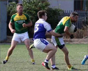  ??  ?? HWH-Bunclody’s William Atkinson looks to go past Ballyhogue’s Dean Doyle.