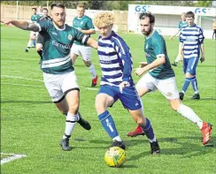  ?? Picture: Tracey Corps ?? Biddenden (blue) on the ball against Ashford 3rds