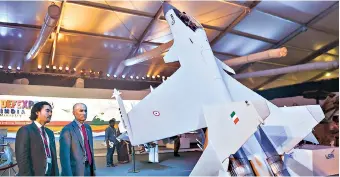  ?? PHOTO: PTI ?? Visitors look at a model of the Sukhoi Su-30 military jet on the third day of Defexpo 2018 in Chennai on Friday