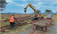  ?? ?? Back to the future! Narrow gauge tracks being used to transport broad gauge track panels, just as contractor­s might have done building the line in 1895. JIM DEEGAN