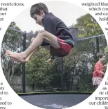  ?? PETER MEECHAM/THE PRESS ?? River Bakker and Mira play on the trampoline at home in New Brighton. The trampoline was paid for with Whaikaha disability funding.