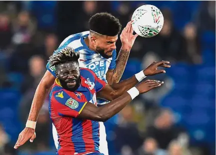  ??  ?? Tough to watch: Crystal Palace’s Bakary Sako vying with Huddersfie­ld’s Philip Billing (top) during the English League Cup third round match at Selhurst Park on Tuesday. — AFP