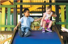  ?? ASSOCIATED PRESS FILE PHOTOS ?? A little girl is watched over by her adopted brother, whose native country is Guatemala. One mother who raised an adopted Hispanic daughter says the girl raised her awareness of her own unconsciou­s racism and the less subtle biases in their community.