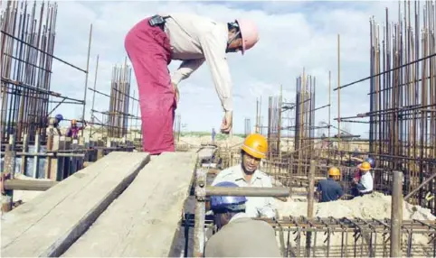  ?? — AFP ?? MAPUTO: In this file picture taken on February 6, 2009 a Chinese supervisor gives instructio­ns to fellow workers on the constructi­on site of the National stadium in Zimpeto.