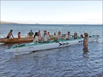  ?? Ella Loui photo ?? The first of two Pu‘ali Koa Kahiko outrigger canoes enters the ocean Friday to bless the expansion of a paddling program that aims to connect military veterans and community members.