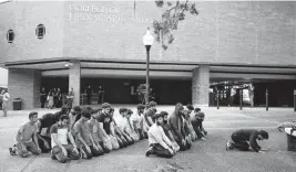  ?? LUIS SANTANA Times ?? Students gather for prayer at the University of Florida’s Turlington Hall after a teach-in organized by the Students for Justice in Palestine to discuss the Israel-Hamas war on Oct. 12 in Gainesvill­e. The DeSantis administra­tion now says the group must be ‘deactivate­d’ on Florida’s public university campuses.