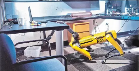  ?? MAX AGUILERA-HELLWEG THE NEW YORK TIMES ?? SpotMini, a robot that Boston Dynamics plans to begin selling in the coming year, inspects an object under a desk during a demonstrat­ion.